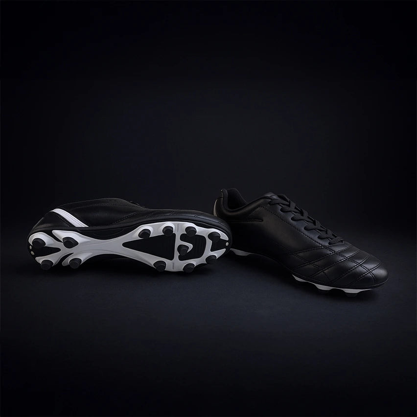 Black Avtiare Classico Cleats on a black background.