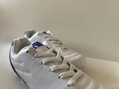 White Avtiare Classico Cleats with a brand logo on a light background